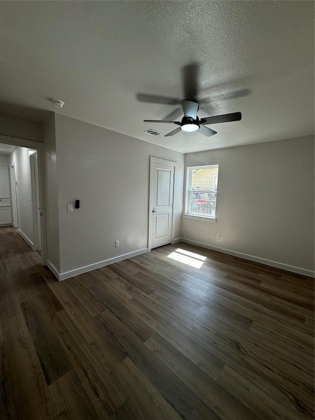 4034 Odessa St, Dallas, TX 75212 - unfurnished bedroom featuring dark wood-type flooring, baseboards, a textured ceiling, and ceiling fan