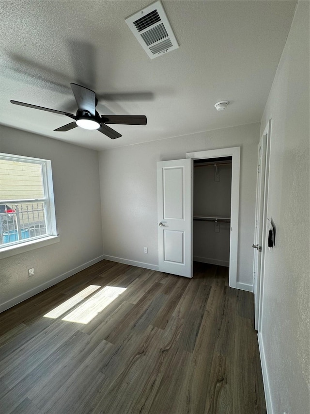 4034 Odessa St, Dallas, TX 75212 - unfurnished bedroom featuring baseboards, dark wood finished floors, a closet, a textured ceiling, and a ceiling fan