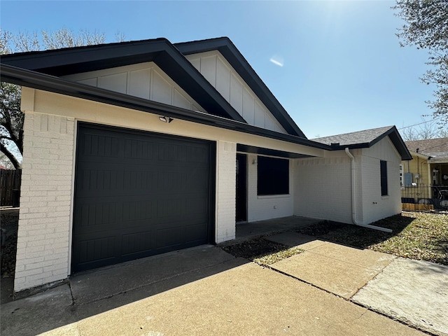 4034 Odessa St, Dallas, TX 75212 - view of front of home featuring brick siding, concrete driveway, board and batten siding, a garage, and roof with shingles