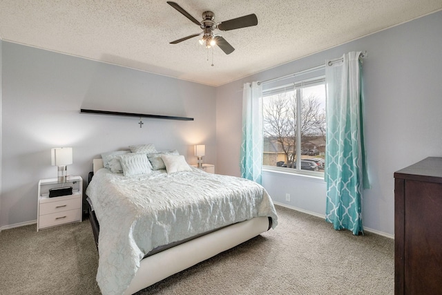 carpeted bedroom featuring baseboards, a textured ceiling, and ceiling fan
