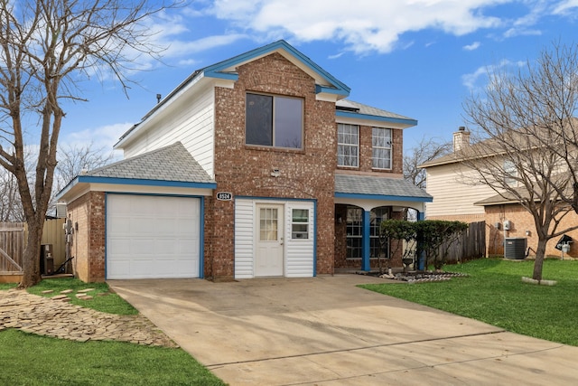 traditional home featuring driveway, a front yard, cooling unit, fence, and brick siding