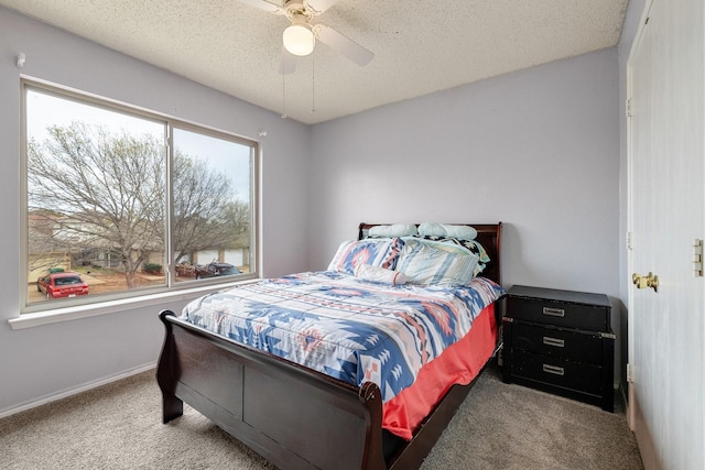 bedroom featuring baseboards, carpet flooring, a textured ceiling, and ceiling fan