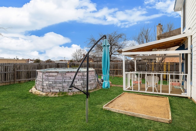 view of yard with a fenced in pool, a fenced backyard, and a patio area