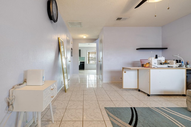 kitchen with marble finish floor, baseboards, ceiling fan, and visible vents