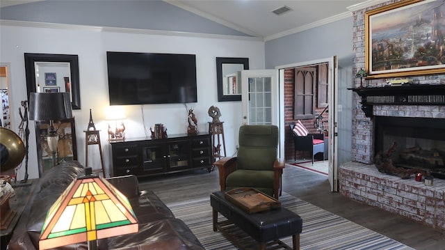 918 Wood St, Royse City, TX 75189 - living area with vaulted ceiling, crown molding, a fireplace, wood finished floors, and visible vents