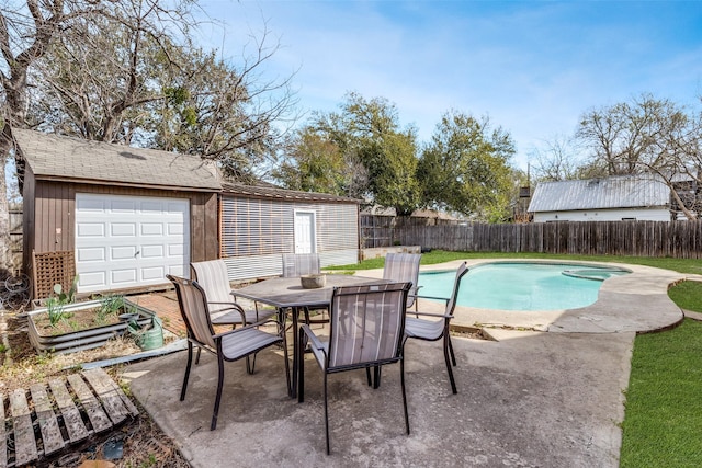 view of swimming pool featuring a fenced in pool, an outdoor structure, a fenced backyard, and outdoor dining space
