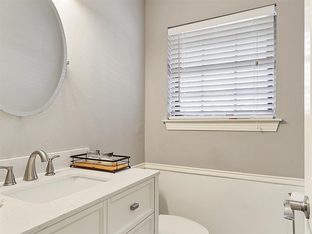 bathroom featuring toilet and vanity