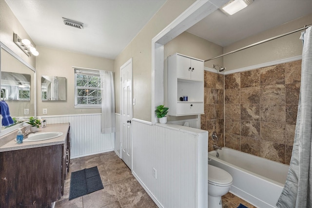 182 Kim St, Mount Vernon, TX 75457 - bathroom featuring vanity, toilet, shower / bath combination with curtain, and a wainscoted wall