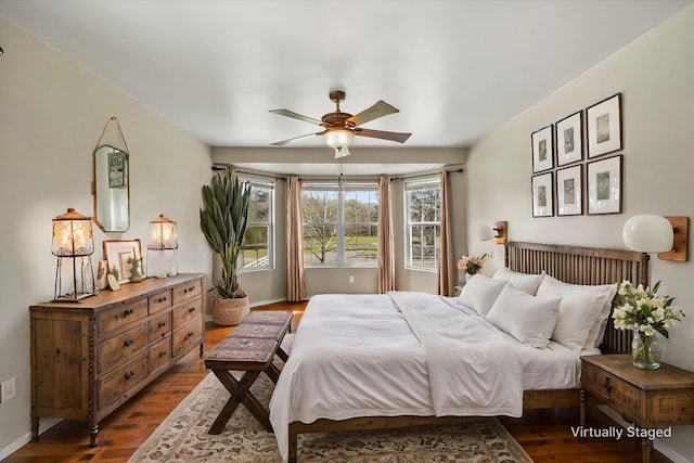 182 Kim St, Mount Vernon, TX 75457 - bedroom with baseboards, a ceiling fan, and dark wood-type flooring