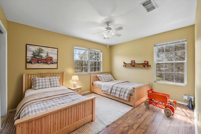182 Kim St, Mount Vernon, TX 75457 - bedroom with baseboards, a ceiling fan, wood finished floors, and visible vents