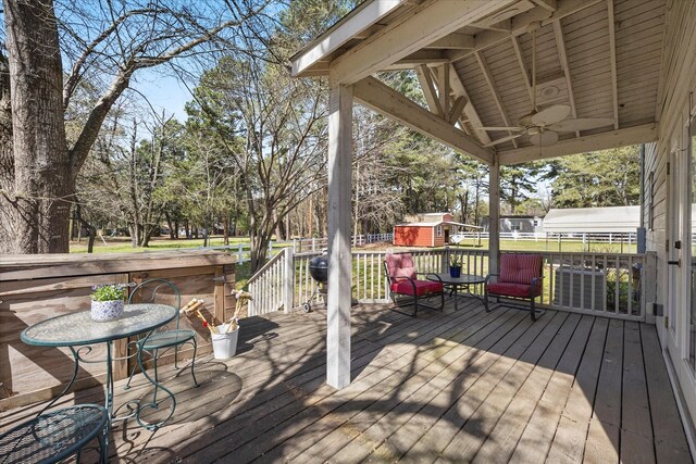 182 Kim St, Mount Vernon, TX 75457 - wooden deck featuring a storage unit, an outbuilding, and a ceiling fan