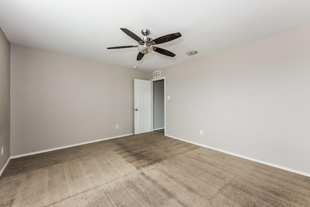 spare room with carpet flooring, baseboards, visible vents, and ceiling fan