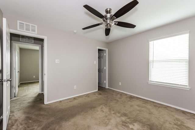 unfurnished bedroom with carpet, visible vents, and baseboards
