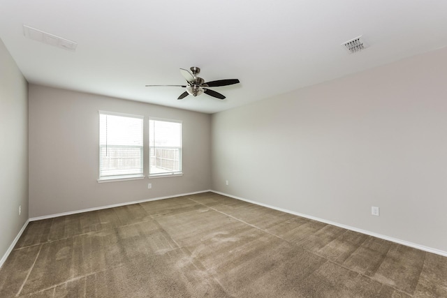 unfurnished room with visible vents, baseboards, ceiling fan, and carpet floors