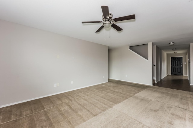 carpeted empty room with baseboards and ceiling fan