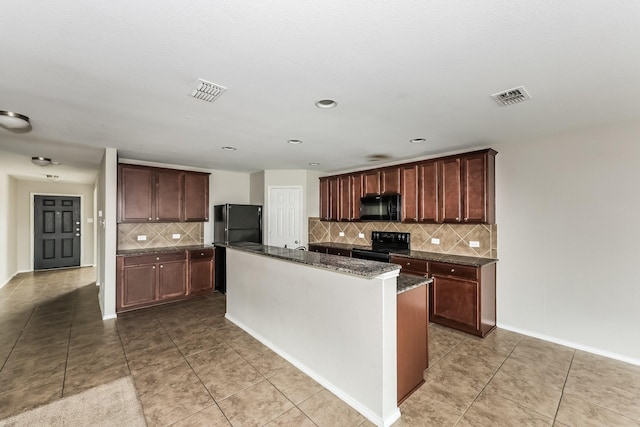 kitchen featuring light tile patterned floors, visible vents, and black appliances