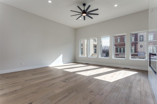 235 E Nash St Unit 113, Grapevine, TX 76051 - empty room featuring a ceiling fan, baseboards, plenty of natural light, and hardwood / wood-style flooring