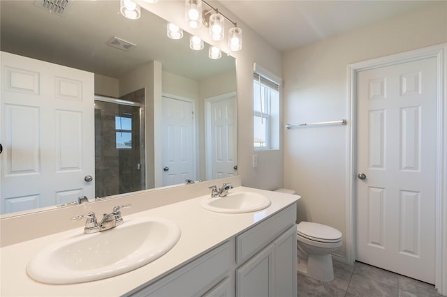 bathroom with visible vents, a stall shower, and a sink