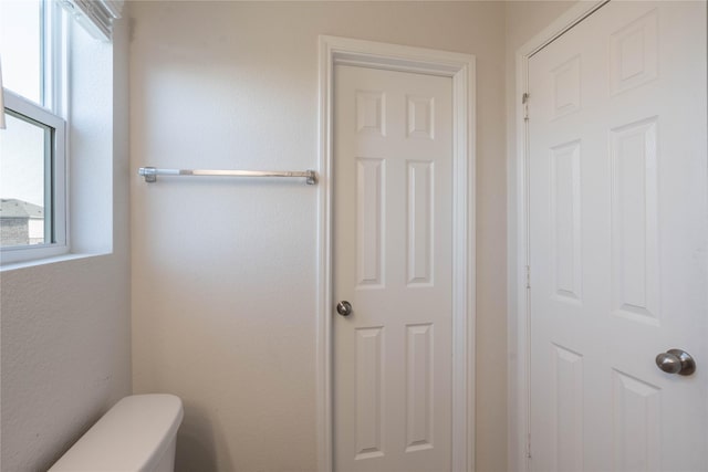 bathroom with a healthy amount of sunlight and toilet