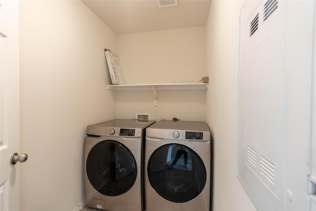 clothes washing area featuring laundry area and separate washer and dryer