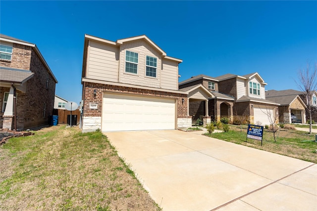 view of front of property with brick siding, an attached garage, concrete driveway, and a front lawn