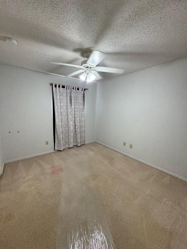 8208 Cloverglen Ln, Fort Worth, TX 76123 - empty room with a ceiling fan, light carpet, baseboards, and a textured ceiling