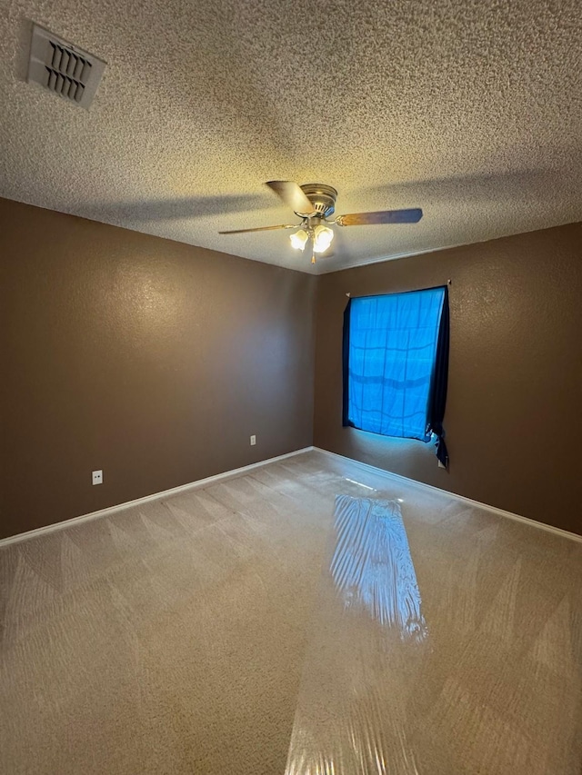 8208 Cloverglen Ln, Fort Worth, TX 76123 - carpeted spare room featuring a ceiling fan, a textured ceiling, baseboards, and visible vents
