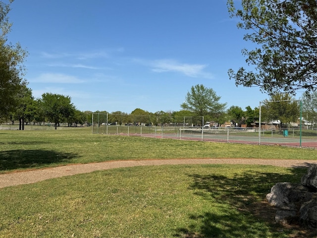 8208 Cloverglen Ln, Fort Worth, TX 76123 - surrounding community with a tennis court, fence, and a yard