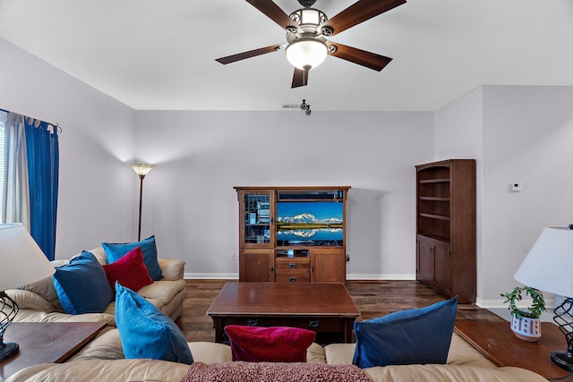 living area with visible vents, baseboards, ceiling fan, and wood finished floors