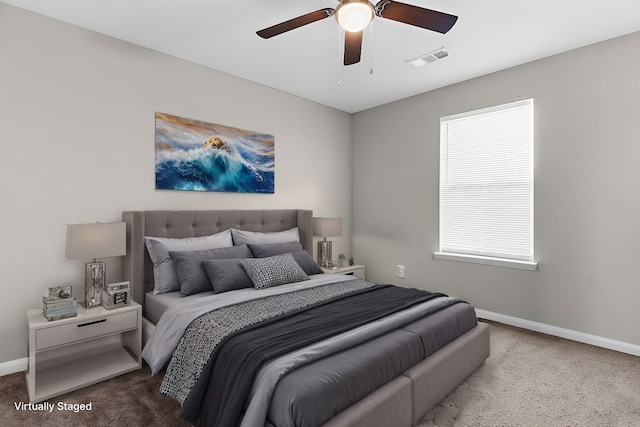 carpeted bedroom featuring baseboards, visible vents, and ceiling fan