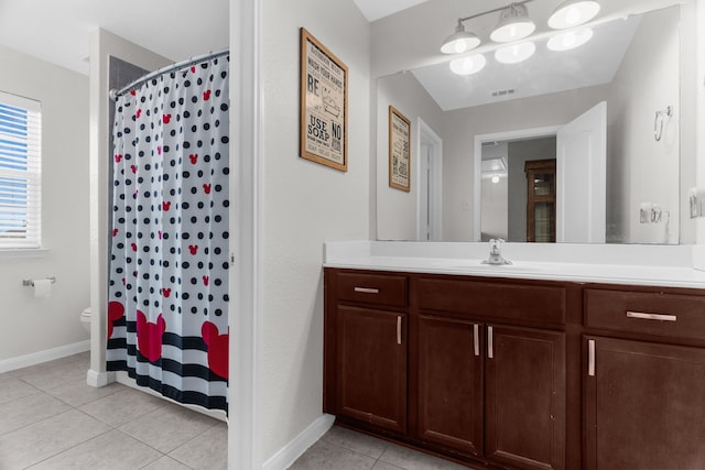 bathroom featuring vanity, visible vents, baseboards, tile patterned flooring, and toilet