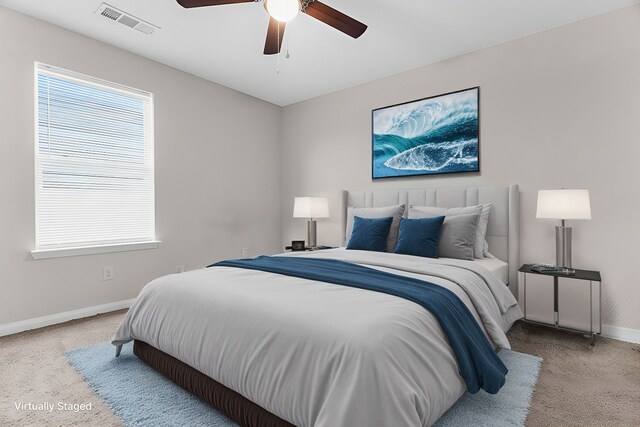 bedroom with visible vents, baseboards, and a ceiling fan