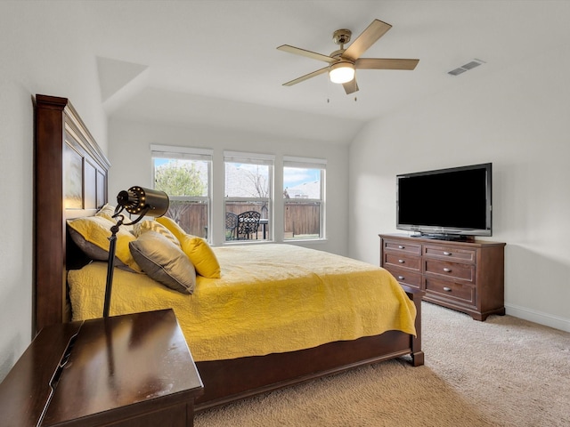 carpeted bedroom with a ceiling fan, baseboards, visible vents, and vaulted ceiling