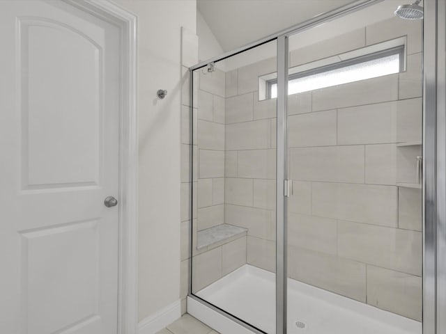 full bath with baseboards and a shower stall
