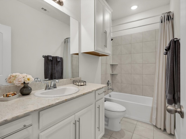 bathroom featuring toilet, visible vents, tile patterned floors, vanity, and shower / bath combo