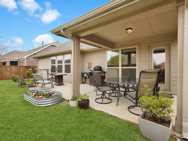 view of patio with outdoor dining area and fence
