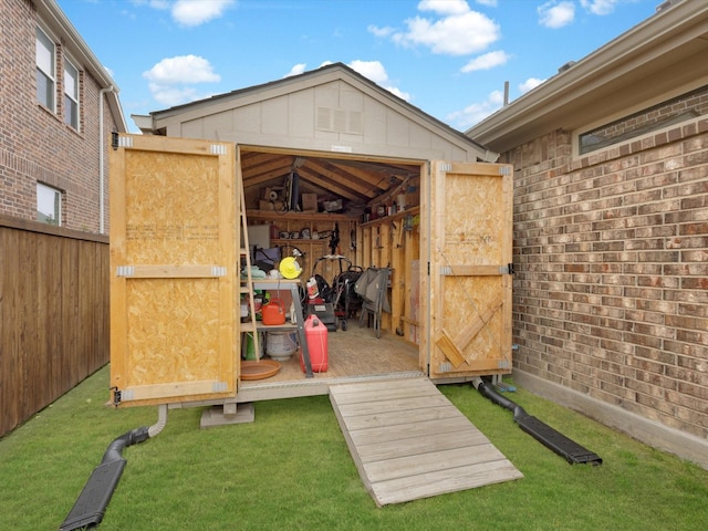 view of shed featuring fence