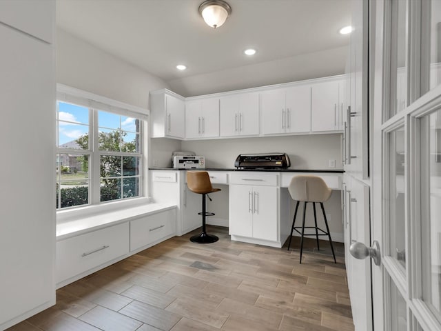 interior space with built in study area, a toaster, light wood-type flooring, and recessed lighting