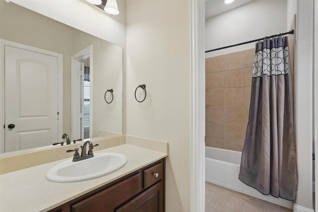 full bathroom featuring shower / bathtub combination with curtain, tile patterned flooring, and vanity