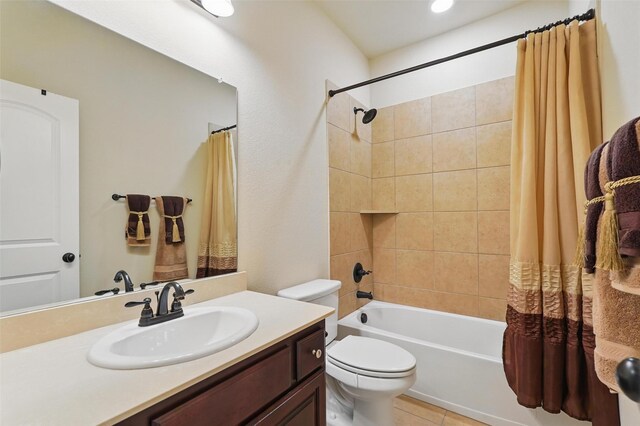 bathroom with vanity, shower / tub combo, tile patterned floors, and toilet