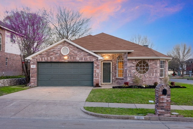 single story home featuring an attached garage, a yard, concrete driveway, and brick siding