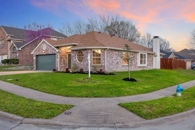 view of front of home featuring a garage, fence, concrete driveway, brick siding, and a front lawn