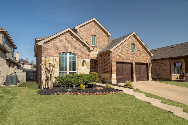 view of front of home with a front lawn, central AC unit, brick siding, and concrete driveway