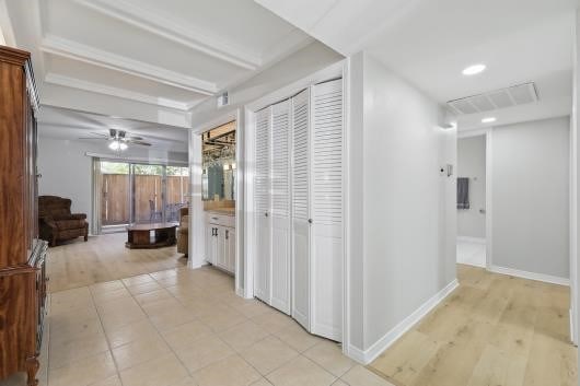 hallway featuring baseboards, light wood-type flooring, visible vents, and recessed lighting