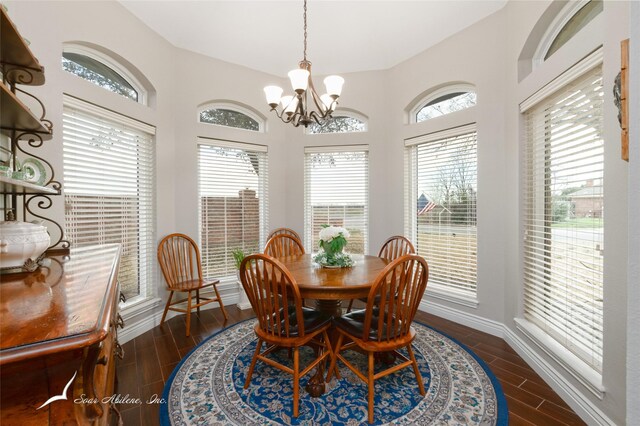 1426 Lakeview Rd, Abilene, TX 79602 - dining room with an inviting chandelier, a healthy amount of sunlight, and dark wood-style floors