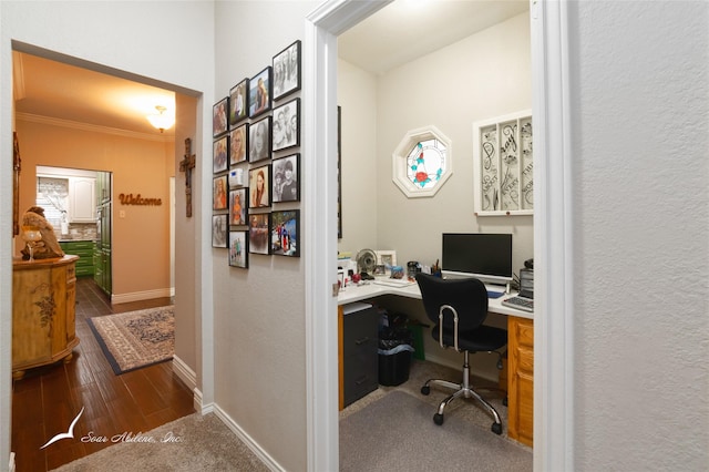 1426 Lakeview Rd, Abilene, TX 79602 - office featuring wood finished floors, built in study area, baseboards, ornamental molding, and a textured wall