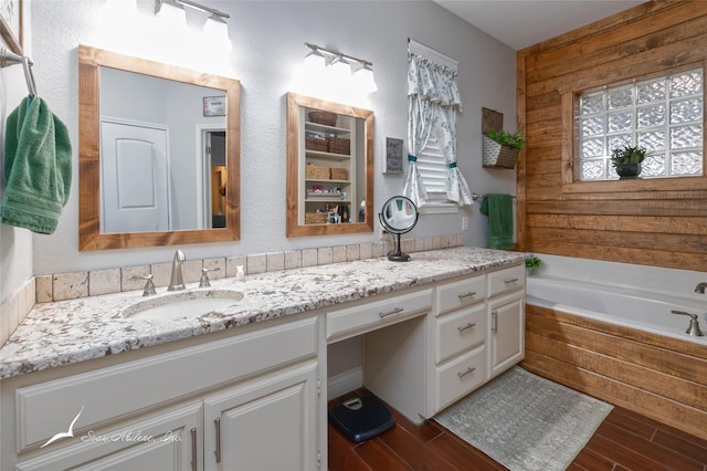 1426 Lakeview Rd, Abilene, TX 79602 - bathroom with vanity, a garden tub, and wood finished floors