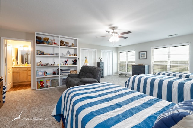 1426 Lakeview Rd, Abilene, TX 79602 - bedroom featuring connected bathroom, ceiling fan, light colored carpet, and visible vents
