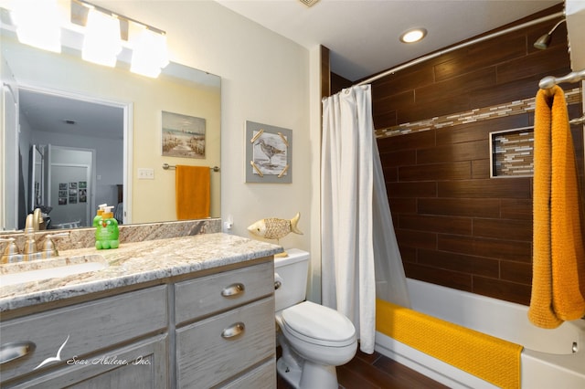 1426 Lakeview Rd, Abilene, TX 79602 - bathroom with vanity, wood finished floors, toilet, shower / bathtub combination with curtain, and recessed lighting