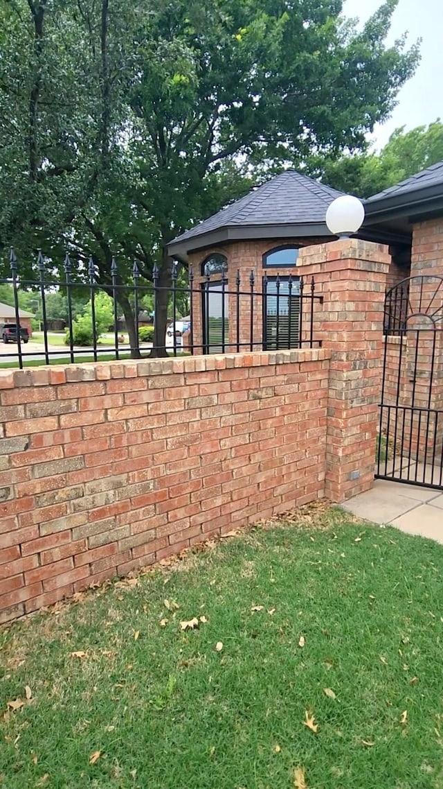 1426 Lakeview Rd, Abilene, TX 79602 - view of home's exterior with brick siding, a lawn, and fence